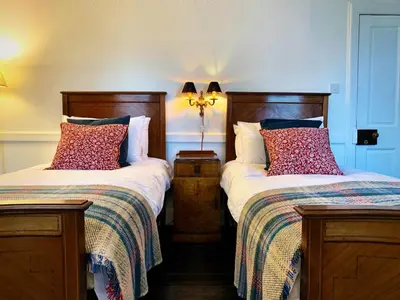 two beds sitting next to each other in a room at 4 Bed in Cardross oc-t30303 in Cardross