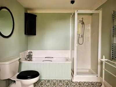 a bathroom with a tub and a toilet and a shower at 4 Bed in Cardross oc-t30303 in Cardross