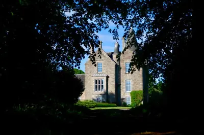 an old stone house with trees in the foreground at 4 Bed in Cardross oc-t30303 in Cardross