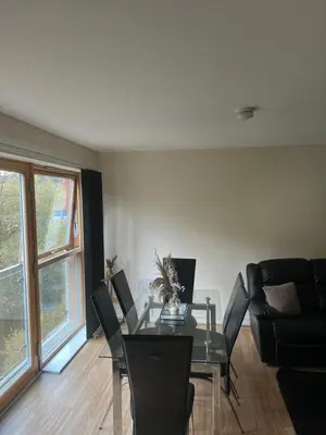 a dining room with a glass table and chairs at Riverview Retreat Shawlands in Mansewood