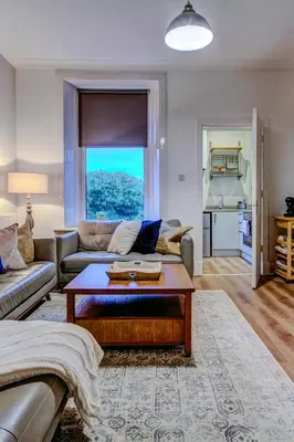 a living room with a couch and a coffee table at The Fullarton - Coorie Doon Stays in Troon