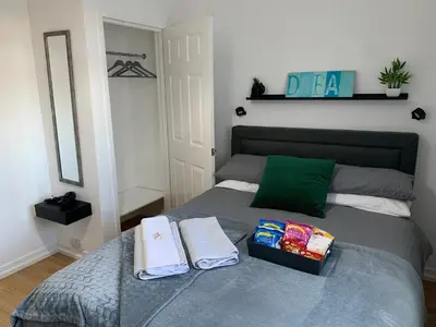a bedroom with a bed with two towels on it at Douglas Apartment - Trains to Edin & Glasgow - Private Parking in Airdrie