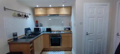 a kitchen with a sink and a stove and a door at Flat in Central Edinburgh New Town , Lothian Road Heart of Edinburgh Flat Sleeps 4 in Edinburgh