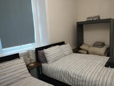 a bedroom with two beds and a window at Flat in Central Edinburgh New Town , Lothian Road Heart of Edinburgh Flat Sleeps 4 in Edinburgh