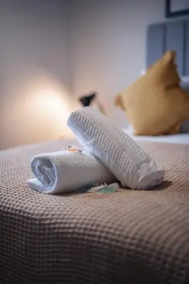 a towel on top of a bed at Franklin Place in East Kilbride