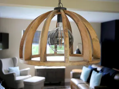 a large wooden chandelier in a living room at Beautiful Cottage in Historical Robert Burns Farm - Pass the Keys in Dumfries