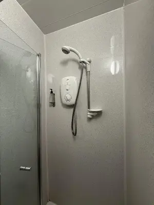 a shower in a bathroom next to a shower at Gothenburg Hotel in Rosyth