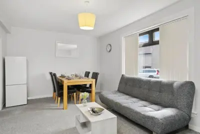 a living room with a couch and a table at BridgeCity Hidden Gem in the heart of Falkirk Roughland house Stirlingshire in Carron
