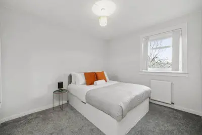 a white bedroom with a bed and a window at BridgeCity Hidden Gem in the heart of Falkirk Roughland house Stirlingshire in Carron