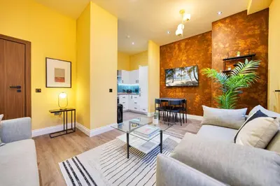 a living room with a couch and a table at Grand Central Station 2 Bed Apartment A1 in Glasgow