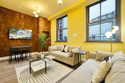 a living room with a couch and a table at Grand Central Station 2 Bed Apartment A1 in Glasgow