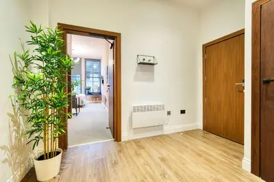 an empty hallway with a door and plants at Grand Central Station 2 Bed Apartment A1 in Glasgow