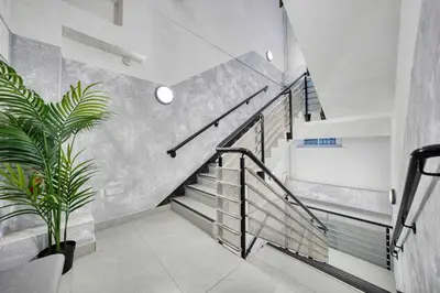a staircase in a house with a potted plant at Grand Central Station 2 Bed Apartment A1 in Glasgow