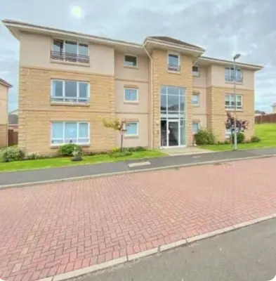 a brick road in front of a house at Modern staycation Apartment in Caldercruix