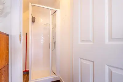a bathroom with a shower with a glass door at 1 Bed in Methven oc-v30533 in Methven