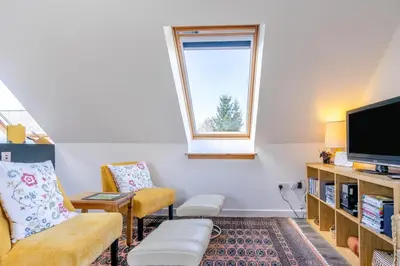 a living room with two chairs and a tv at 1 Bed in Methven oc-v30533 in Methven