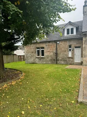 a brick house with a lawn in front of it at The Barn in Hawkhead