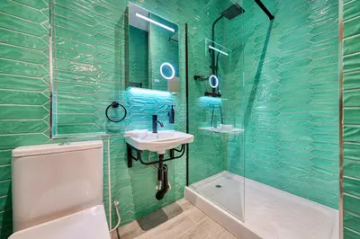 a green tiled bathroom with a sink and a shower at Large Central Station 2 Bed Apartment A2 in Glasgow