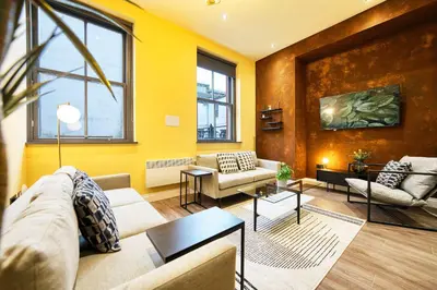 a living room with a couch and a table at Stunning Central Station 2 Bed Apartment B4 in Glasgow