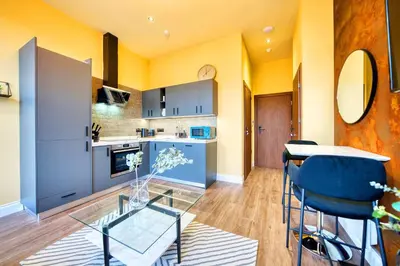 a kitchen and dining room with a glass table and chairs at Cozy Central Station 1 Bed Apartment B8 in Glasgow