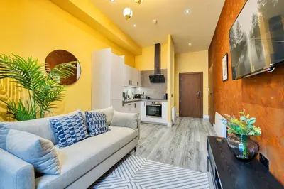 a living room with a couch and a kitchen at Smart Central Station 1 Bed Apartment B11 in Glasgow