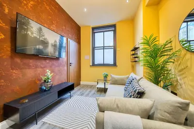 a living room with yellow walls and a couch at Smart Central Station 1 Bed Apartment B11 in Glasgow