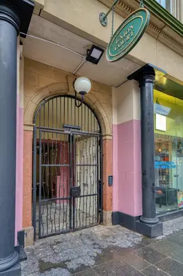 an entrance to a store with a gate on a building at Smart Central Station 1 Bed Apartment B11 in Glasgow
