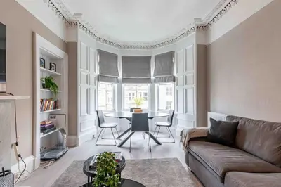 a living room with a couch and a table at Spacious 3 bed home in Marchmont in Edinburgh