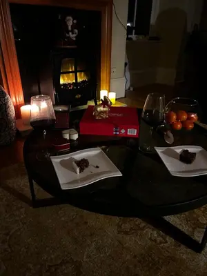 a table with a plate of food and a fireplace at Tower View Apartment in Carrick