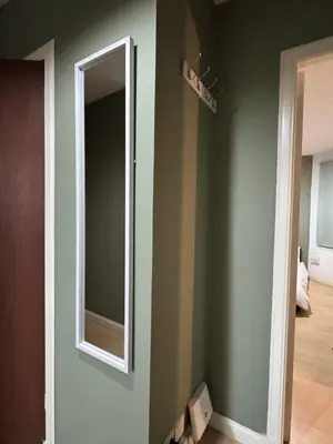 a mirror on a wall in a room at Cozy Central Flat near Edinburgh Castle and with Free Private Parking in Edinburgh