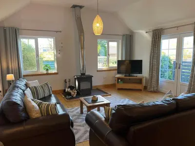 a living room with a couch and a fire place at Callanish Bothy in Benderloch