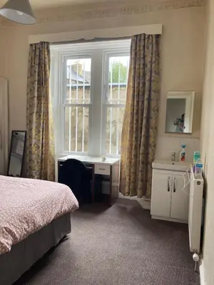 a bedroom with a bed and a window at Gilmore Flat in Edinburgh