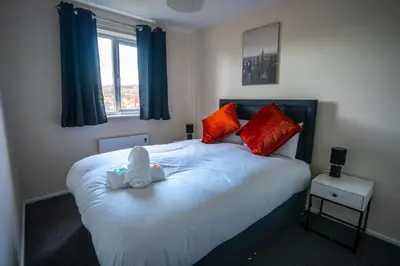 a bedroom with a bed with a stuffed animal on it at 1 BDR Apartment At Caledonia Luxe Stays Short Lets & Serviced Accommodation Airdrie in Airdrie