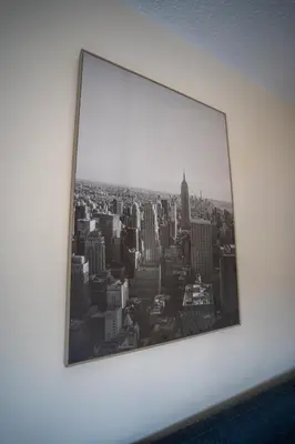 a framed picture of a city on a wall at 1 BDR Apartment At Caledonia Luxe Stays Short Lets & Serviced Accommodation Airdrie in Airdrie