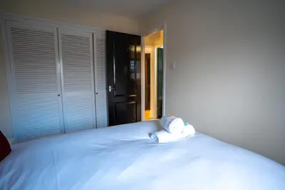 a white bed with two towels on top of it at 1 BDR Apartment At Caledonia Luxe Stays Short Lets & Serviced Accommodation Airdrie in Airdrie