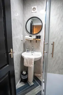 a bathroom with a sink and a mirror at 1 BDR Apartment At Caledonia Luxe Stays Short Lets & Serviced Accommodation Airdrie in Airdrie