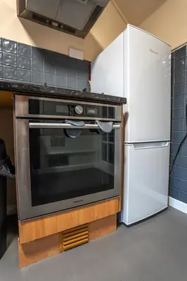a kitchen with a stove and a refrigerator at Skye House in Grangemouth
