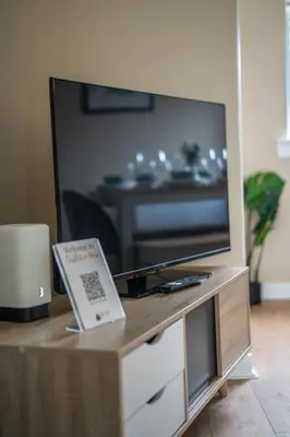 a flat screen tv sitting on top of a table at Castlefern House in Rutherglen