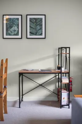 a desk in a room with two pictures on the wall at Modern flat near Murrayfield stadium, sleeps 4 in Edinburgh