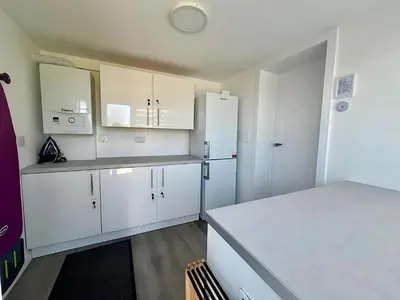 a kitchen with white cabinets and white appliances at Dunmuir House 4 Bedroom 2 bathroom House & Garden in Denny in Falkirk