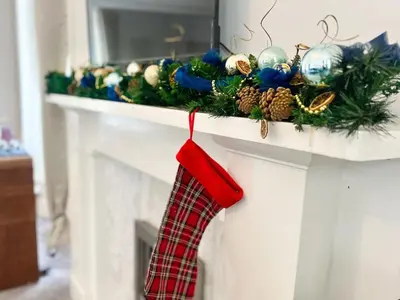 a fireplace with christmas ornaments on a mantle at 10 Bedrooms Pool Table Garden Piano in Glasgow