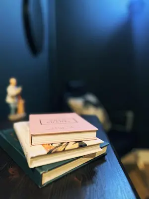 a stack of books sitting on top of a table at Central Designer Flat by Castle in Edinburgh