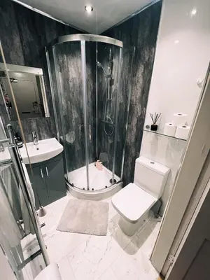 a bathroom with a shower and a toilet and a sink at Central Designer Flat by Castle in Edinburgh