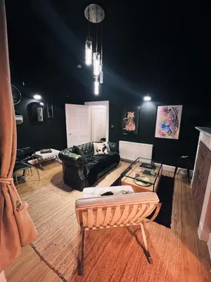a living room with a couch and a table at Central Designer Flat by Castle in Edinburgh