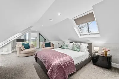 a bedroom with a large bed and a window at Westcraigs in Westfield