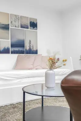 a living room with a white couch and a glass coffee table at Modern 2 bedroom apartment in City Centre in Edinburgh