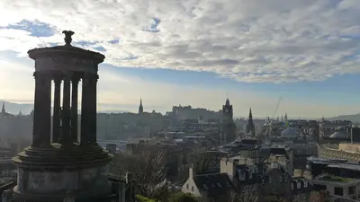 a view of a city with a statue on top of a building at Modern 2 bedroom apartment in City Centre in Edinburgh
