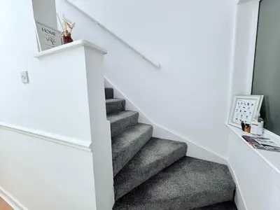 a staircase with grey carpeting and a white stair case at RF-Entire House-Central Scotland-Falkirk, Self-Check-in , Pet-friendly and with Parking in Falkirk