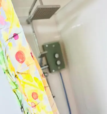a curtain in a hospital room with a light at Tin Lid Cottage - cosy ground floor flat in Banton