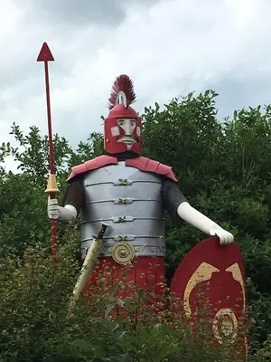 a statue of a man dressed in armor holding a sword at Tin Lid Cottage - cosy ground floor flat in Banton